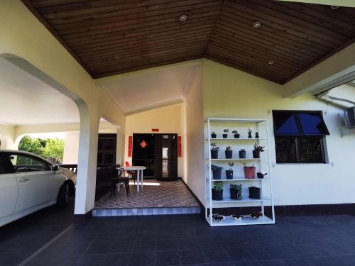 a house with a car parked in a garage at 机场附近的民宿B in Nadi