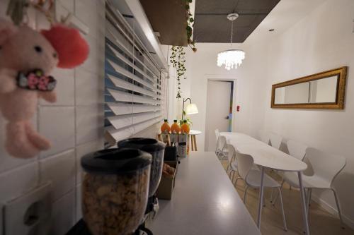 a dining room with white tables and white chairs at Soo Guest House in Seoul