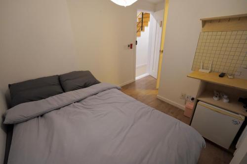 a bedroom with a bed in a room at Soo Guest House in Seoul