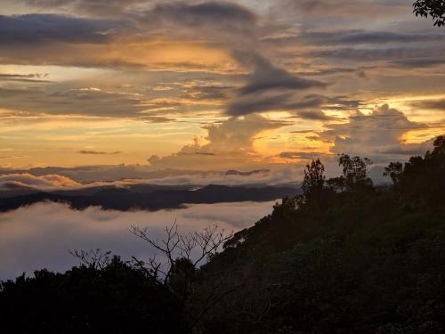 a view of a sunset with clouds in the sky at GlenMyu Estate in Haputale