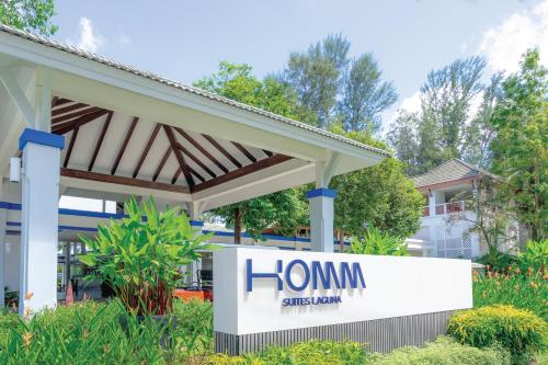 a home sign in front of a building at Homm Suites Laguna, part of Banyan Group in Bang Tao Beach