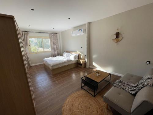a bedroom with a bed and a couch and a table at Al Hada Hills Residential Unit in Al Hada