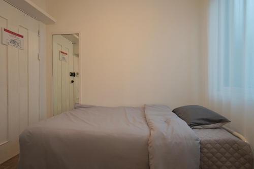 a bedroom with a bed with a pillow on it at Soo Guest House in Seoul