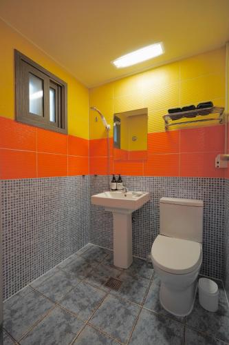 a bathroom with a toilet and a sink at Soo Guest House in Seoul
