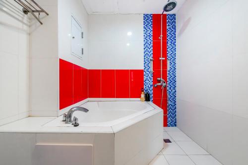 a bathroom with a sink and red and blue tiles at Wei Yuan Hotel in Kenting