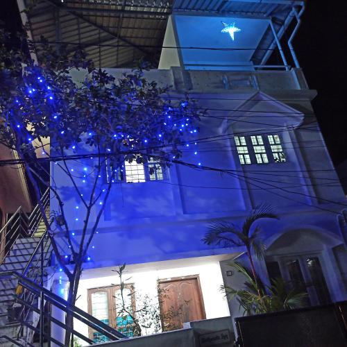 a building with blue lights in front of it at Bethesda Inn in Cochin