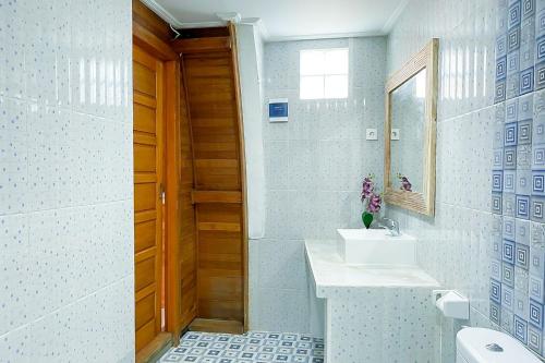a bathroom with a sink and a mirror at The Lavana Puri Lumbung Agave - Minimum stay 30 nights in Canggu
