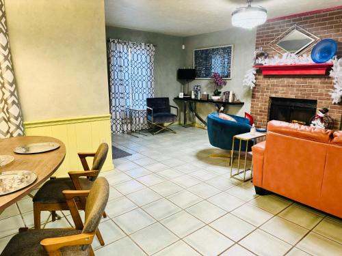 a living room with a couch and a fireplace at A Bliss of Color Townhouse in Jackson