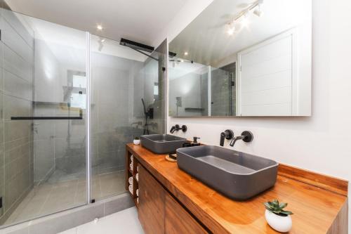a bathroom with two sinks and a shower at Brand new, Beachfront Ocean Terraces, Poste Lafayette-Apt-C4 in Poste Lafayette