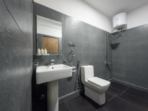 a bathroom with a sink and a toilet and a mirror at The Mount View Single Tree Hotel in Nuwara Eliya