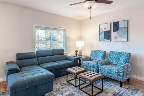 a living room with a couch and a chair at Business in Front and Fun in the Back Pets too in Orem