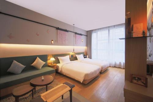 a hotel room with a bed and a couch at Timeless Boutique House Shanghai in Shanghai