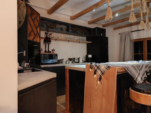 una cucina con armadi neri e piano di lavoro di Luxury Larch Loft a Tesido