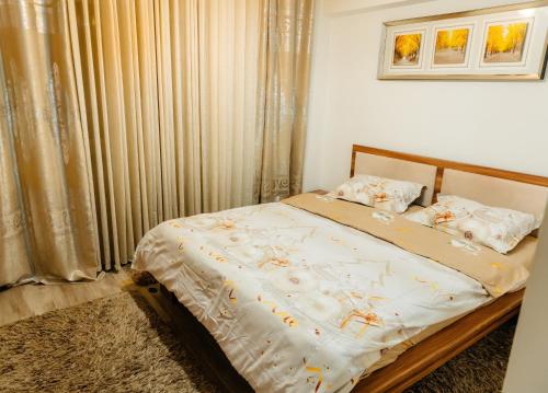 a bedroom with a bed in a room with curtains at Glamour Ultracentral in Craiova