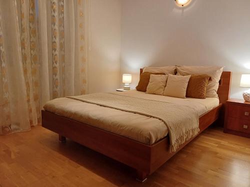 a bedroom with a large bed with two lamps on it at Apartament pod Nosalem in Zakopane