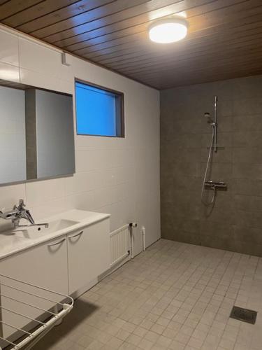 a bathroom with a shower and a sink at Apartment HILLI in Rovaniemi