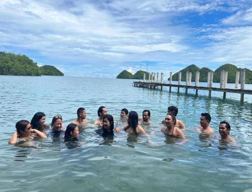 a group of people swimming in the water at C View Resort in Sipalay