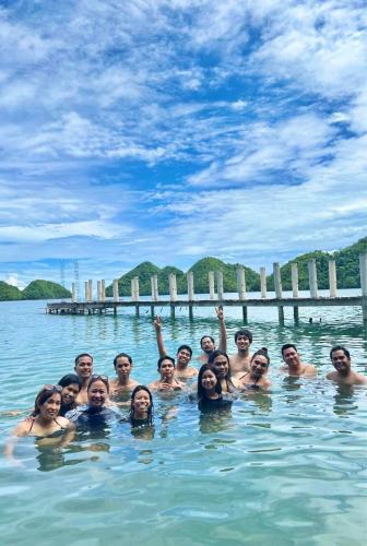 a group of people swimming in the water at C View Resort in Sipalay