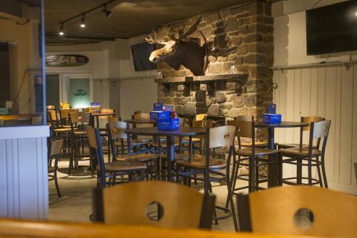 a restaurant with tables and chairs and a bull head on the wall at Split Rock Resort in Lake Harmony