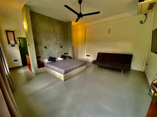 a bedroom with a bed and a couch in a room at Sesatha lake Kandy in Kandy