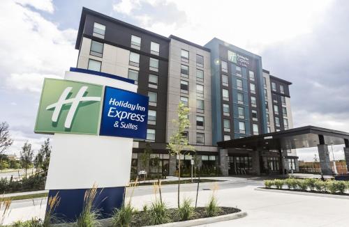 an office building with a sign in front of it at Holiday Inn Express & Suites Toronto Airport South by IHG in Toronto