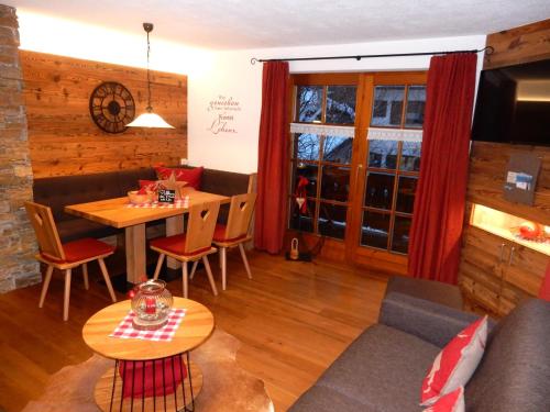 ein Wohnzimmer mit einem Sofa und einem Tisch in der Unterkunft Gästehaus Schönfeld in Reit im Winkl