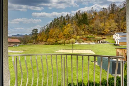 a view of a park from a balcony at Honeycomb Chalets And Apartments Mozirje in Mozirje
