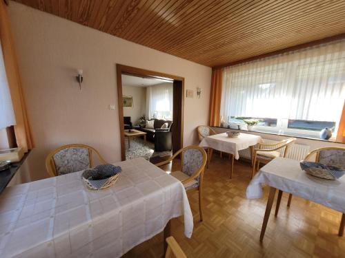 une chambre avec deux tables et des chaises ainsi qu'un salon dans l'établissement Ferienhaus Wellsandt, à Norderney