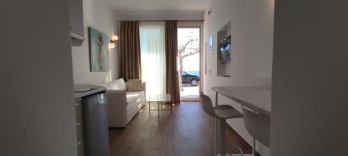 a room with a kitchen with a couch and a table at Nostos in Patitiri