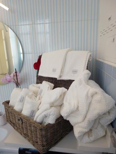 a basket of towels on a counter in a bathroom at Lovely apartment with terrace by Alterego in Villanova dʼAsti