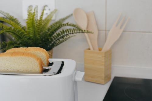 a loaf of bread sitting on top of a toaster at Larios Premium Apartments in Málaga