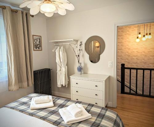 a bedroom with a bed with two towels on it at LE CEMAROSE Cottage & Spa Terrace Garden & lovely View in Épernay