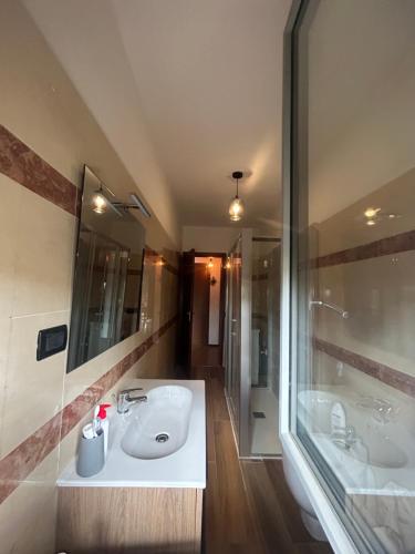 a bathroom with two sinks and a shower and a tub at Vespucci 23 in Alessandria