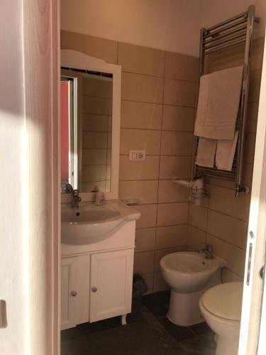 a bathroom with a sink and a toilet and a mirror at B&B Vista Mare in Naples
