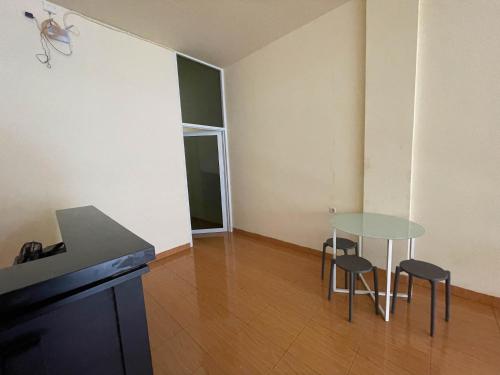 a small room with a table and chairs in it at RedDoorz at Ramelau near AP Pettarani in Makassar
