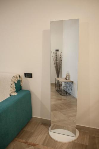 a room with a green couch and a glass wall at Live and Love Italy in Monopoli