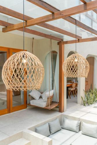 two baskets hanging from the ceiling of a patio at Alegria de la Vida in Canggu