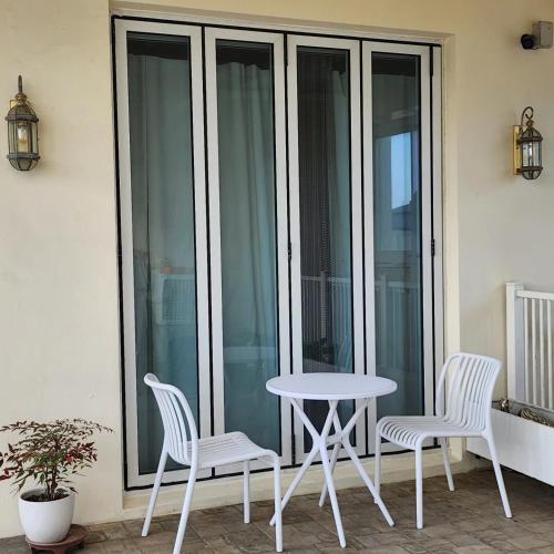 a table and two chairs sitting on a balcony at HANI Haus in Jeju