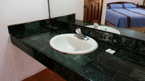 a bathroom sink with a green counter top at Perla Maya Hotel in Panajachel