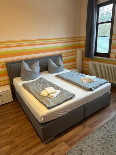 a bed with two pillows on it in a room at Ferienwohnung Baars in Bad Sachsa