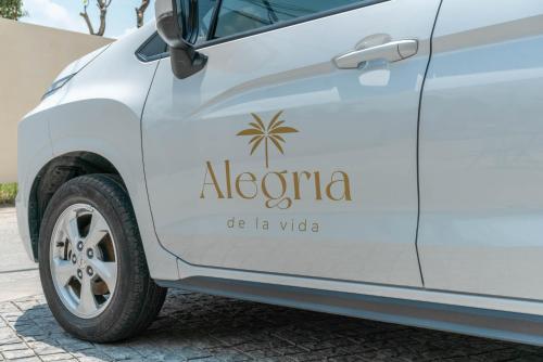 a white van with a palm tree on the side at Alegria de la Vida in Canggu