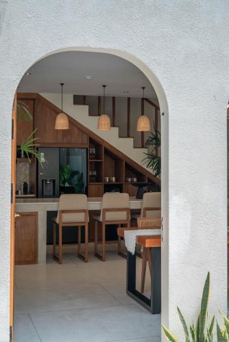 an archway leading into a dining room and kitchen with a staircase at Alegria de la Vida in Canggu