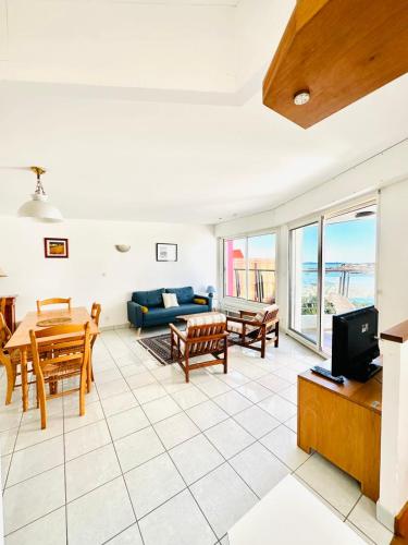 un salon avec un canapé et une table dans l'établissement Charmante maison les pieds dans l'eau, à Ploemeur