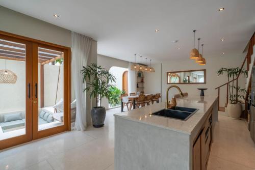 a kitchen with a sink and a living room at Alegria de la Vida in Canggu