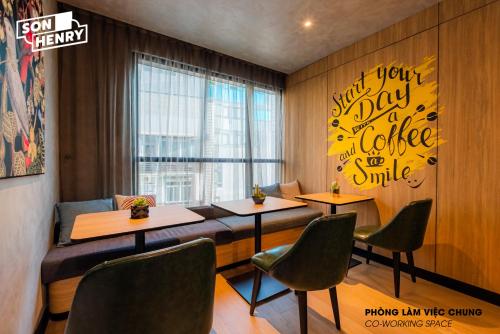 a restaurant with two tables and chairs and a window at Son&Henry Zenity District 1 in Ho Chi Minh City