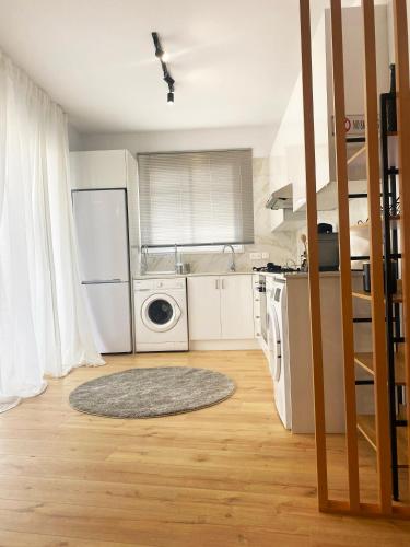 a kitchen with a refrigerator and a washing machine at Luxury City Retreat- 2-Bedroom, 2-Bath Apartment in Nicosia