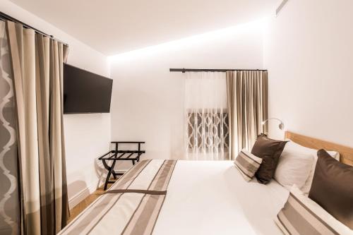 a bedroom with a bed and a window at Bordoy Mostatxins - Hotel Boutique Adults Only in Alcudia