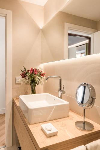 a bathroom with a white sink and a mirror at Bordoy Mostatxins - Hotel Boutique Adults Only in Alcudia