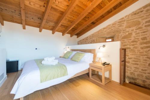 a bedroom with a white bed and a wooden ceiling at Bordoy Mostatxins - Hotel Boutique Adults Only in Alcudia