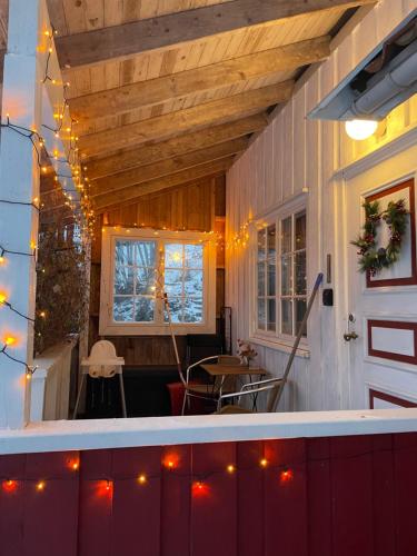 a porch with christmas lights on a house at Koselig anneks i Heggedal! in Asker